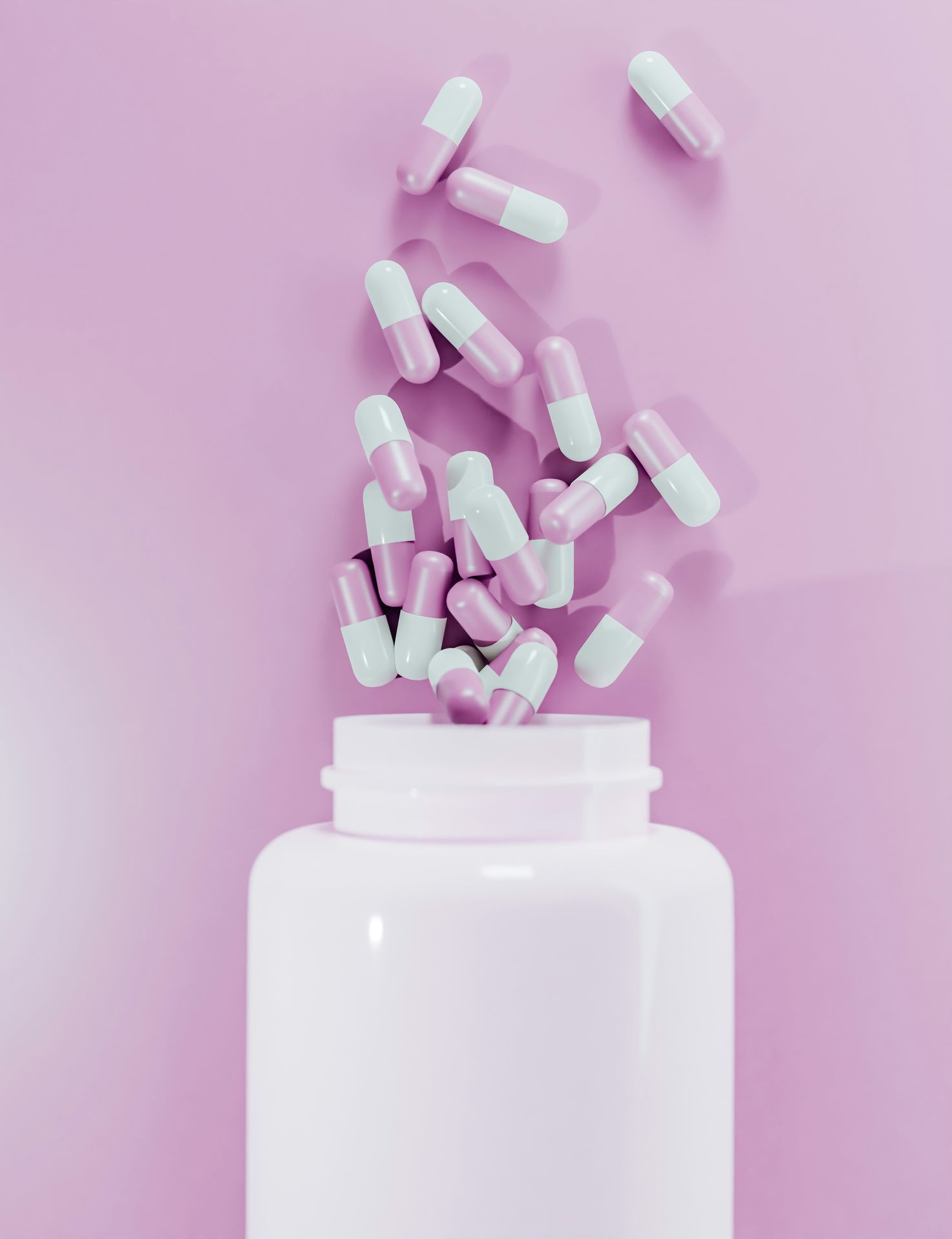 Capsules spilling from a white supplement bottle