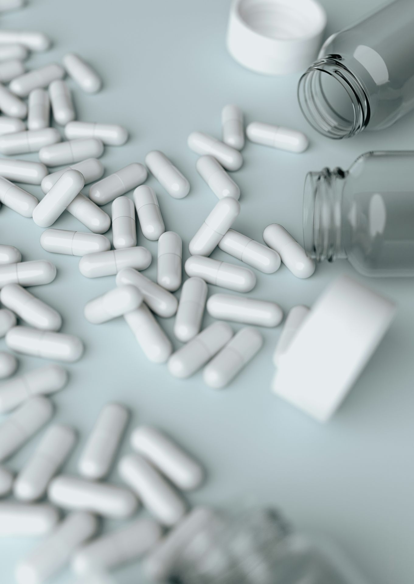 White capsules with bottles on a clean surface